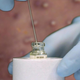 A vial of smallpox vaccine overlaid on a photo of the virus’s effects.